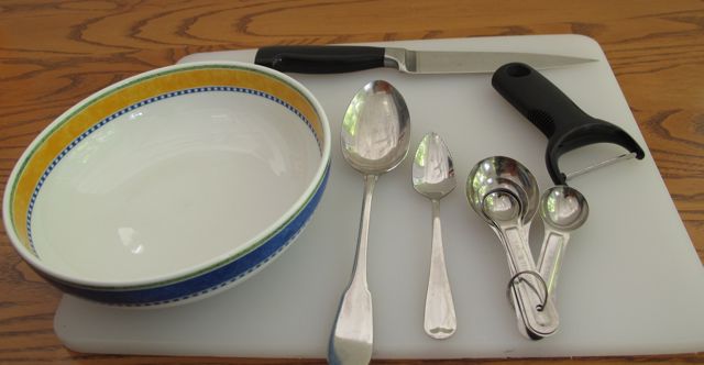 kitchen utensils, vegetable peeler, kitchen knife, cutting board, bowl, spoon