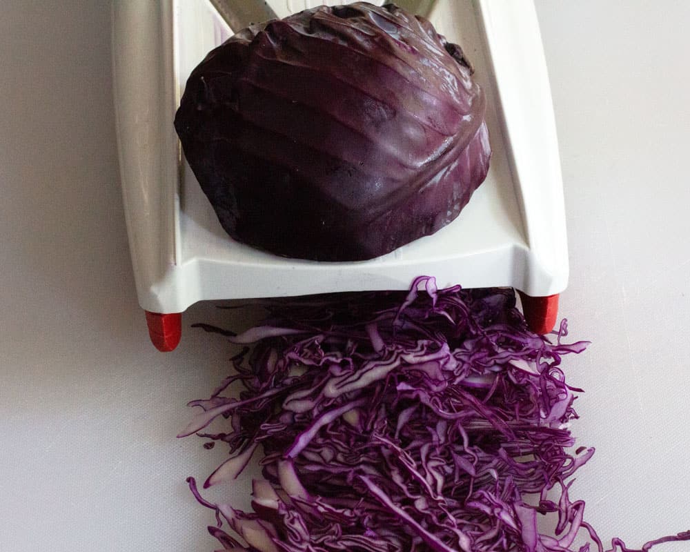 using a mandoline to shred red cabbage