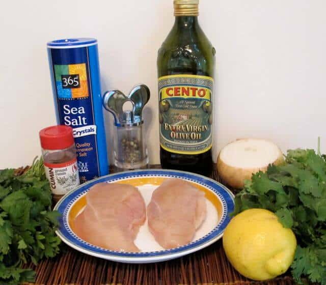 ingredients for chicken shish kebab, parsley, cilantro, onion, lemon, olive oil