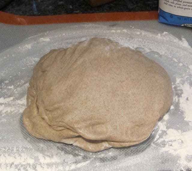 bread on counter being punched down after kneading
