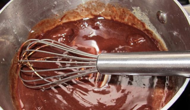 whisking chocolate into cupcake glaze