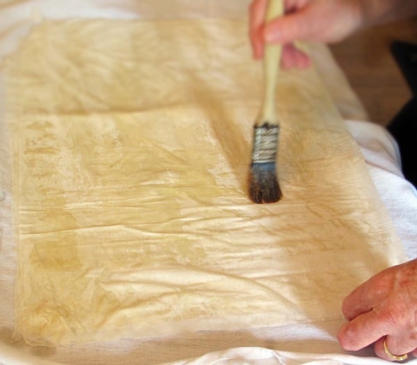 brushing oil or butter onto sheets of fillo dough