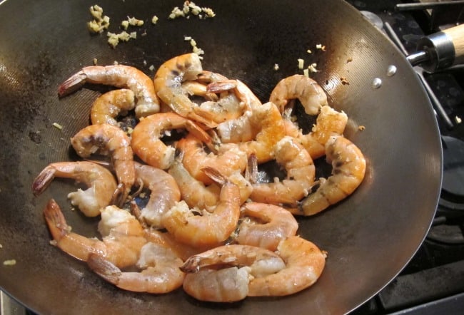 cooking ginger and garlic and shrimp in wok