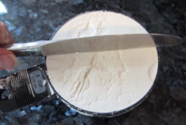 Measuring flour for currant scones.