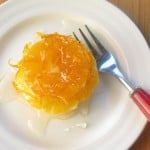oranges and clementines in syrup on a plate with a fork