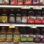 bottles of apple juice on a store shelf