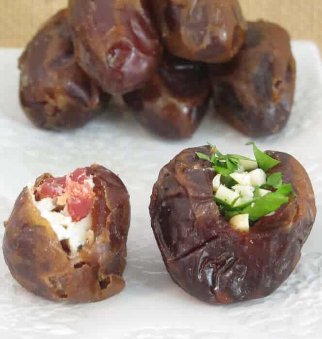 dates split open with fillings in front of uncut dried dates 