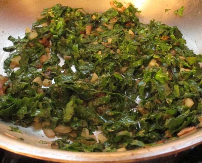 Cooking kale strips for stuffing. 