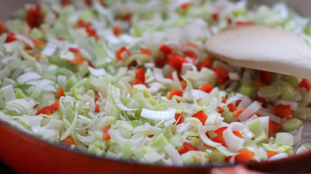 Sauteing leeks, celery and red bell pepper for stuffing.