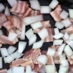 Bacon and onion at the bottom of slow cooker, for Easy Slow Cooker Jamaican Baked Beans