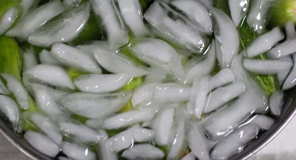 Cooling the cucumbers, the first step in making Spicy Sweet Pickles.