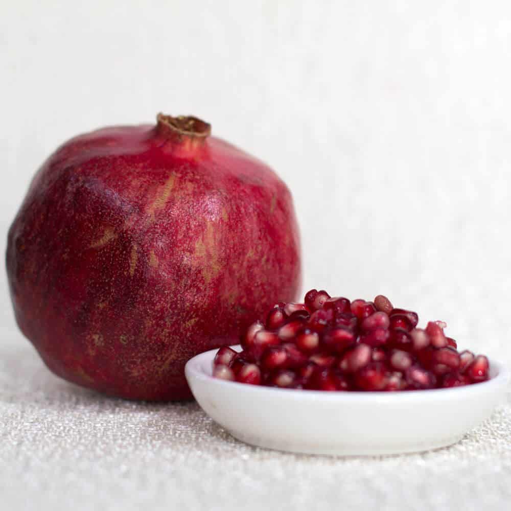 pomegranate with seeds on the side