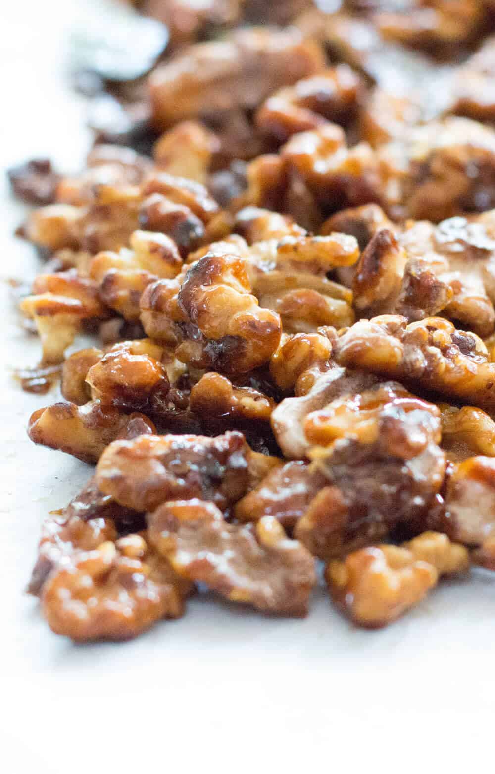 Stovetop candied walnuts cooled on parchment paper