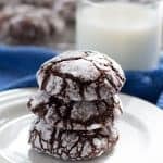 Stack of Fudgy Chocolate Crinkle Cookies with a glass of milk | Mother Would Know