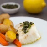 Fish with lemon caper sauce and ingredients behind
