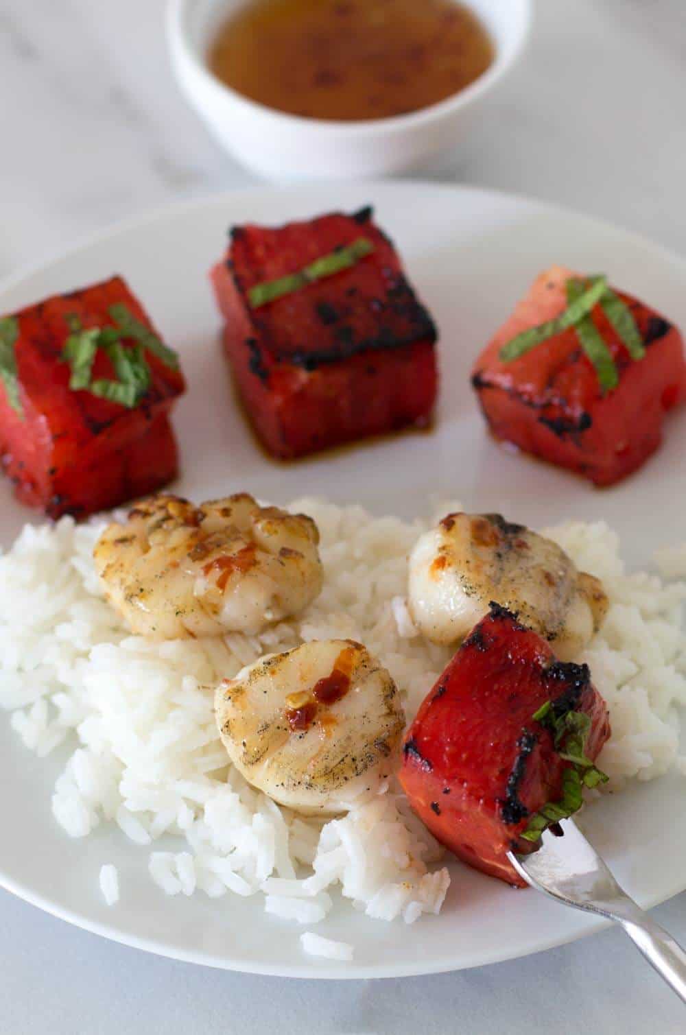 Grilled Watermelon Scallop Shish Kebobs on a bed of rice. 