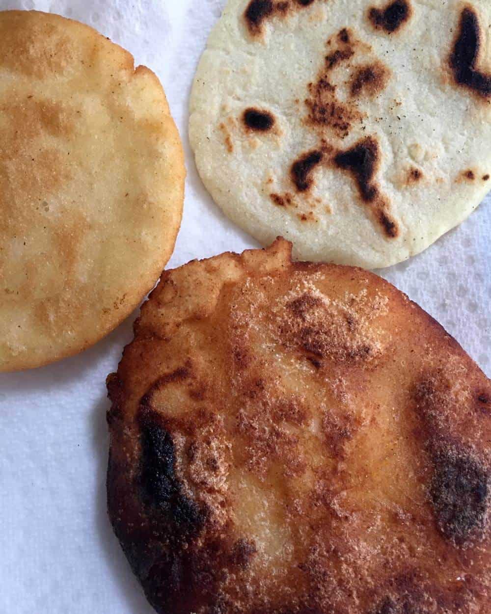 3 arepas cooked, on a paper towel