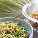 Crunchy Napa cabbage salad with a cabbage leaf and crunchies in a bowl