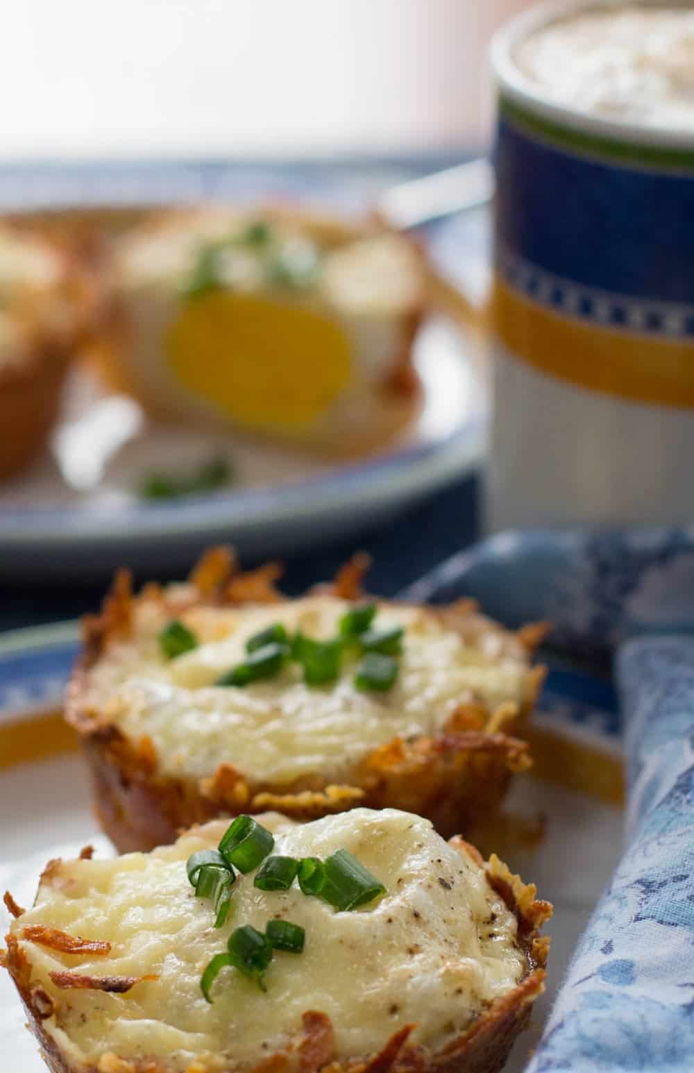 Cheesy hash brown egg nests with coffee cup