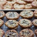 Passover florentine chocolate cookies drying on rack with freshly baked cookies in background