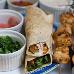 chicken kathi rolls done surrounded by chicken and toppings