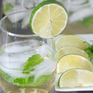 Hugo cocktail with a plate of lime and mint