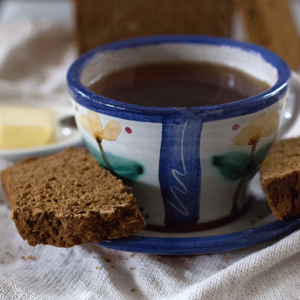 Two slices of authentic Guinness Irish brown bread with tea and butter 