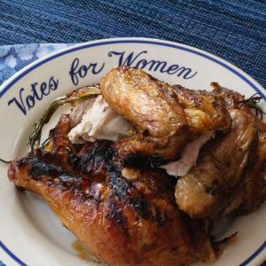 piece of spatchcocked grilled chicken on "Votes for 'Women" plate