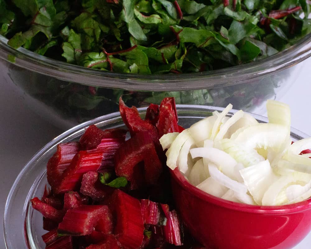 Swiss chard and onions cut and ready to cook