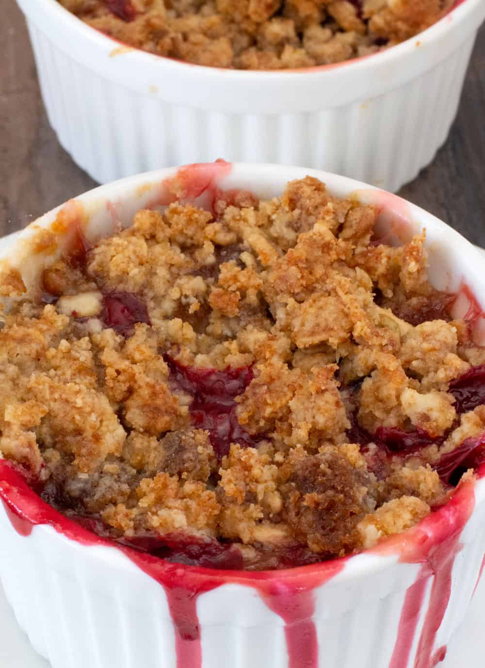 baked fruit with granola streusel topping in a small ramekin ready to eat