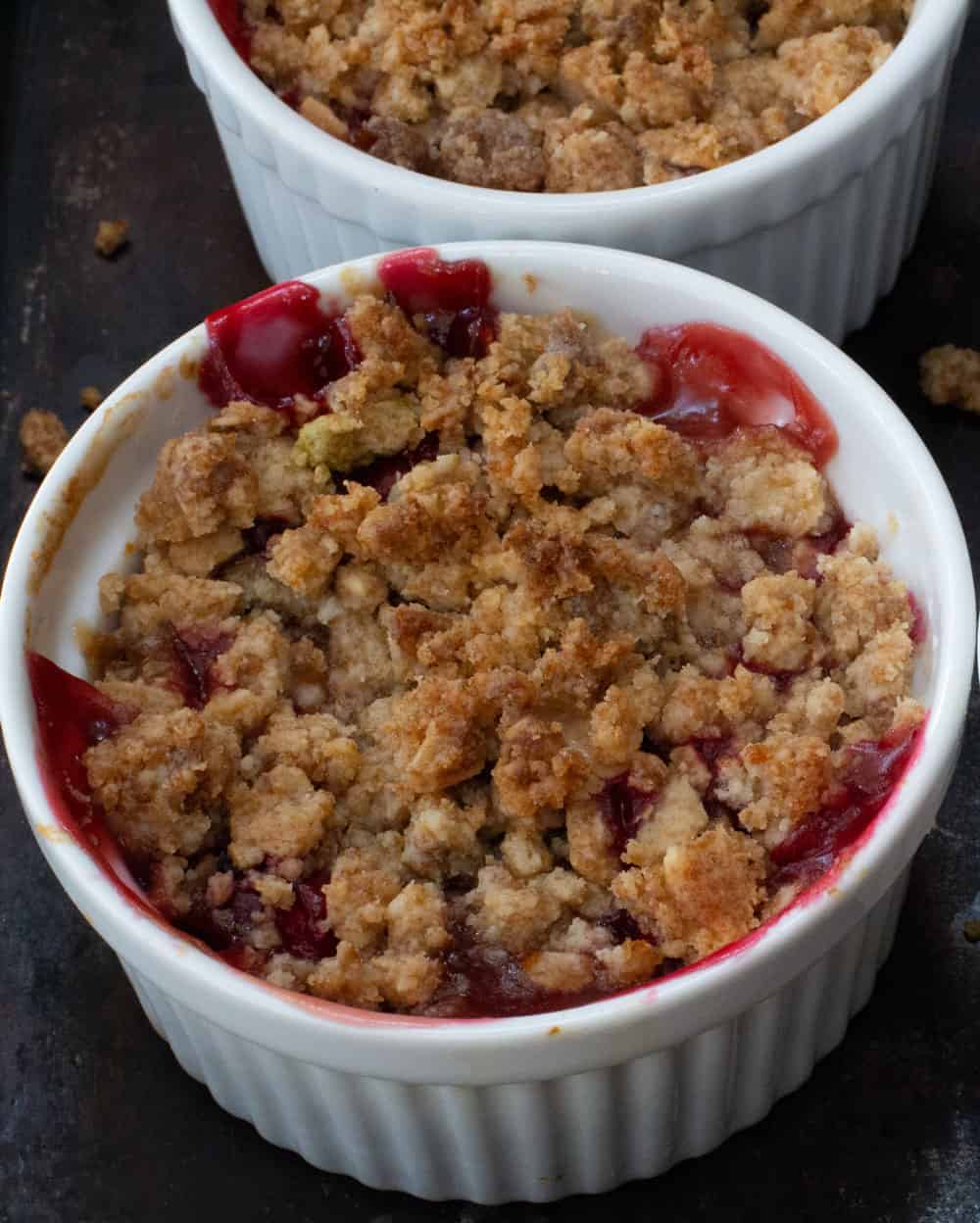 a ramekin of baked fruit with granola streusel topping