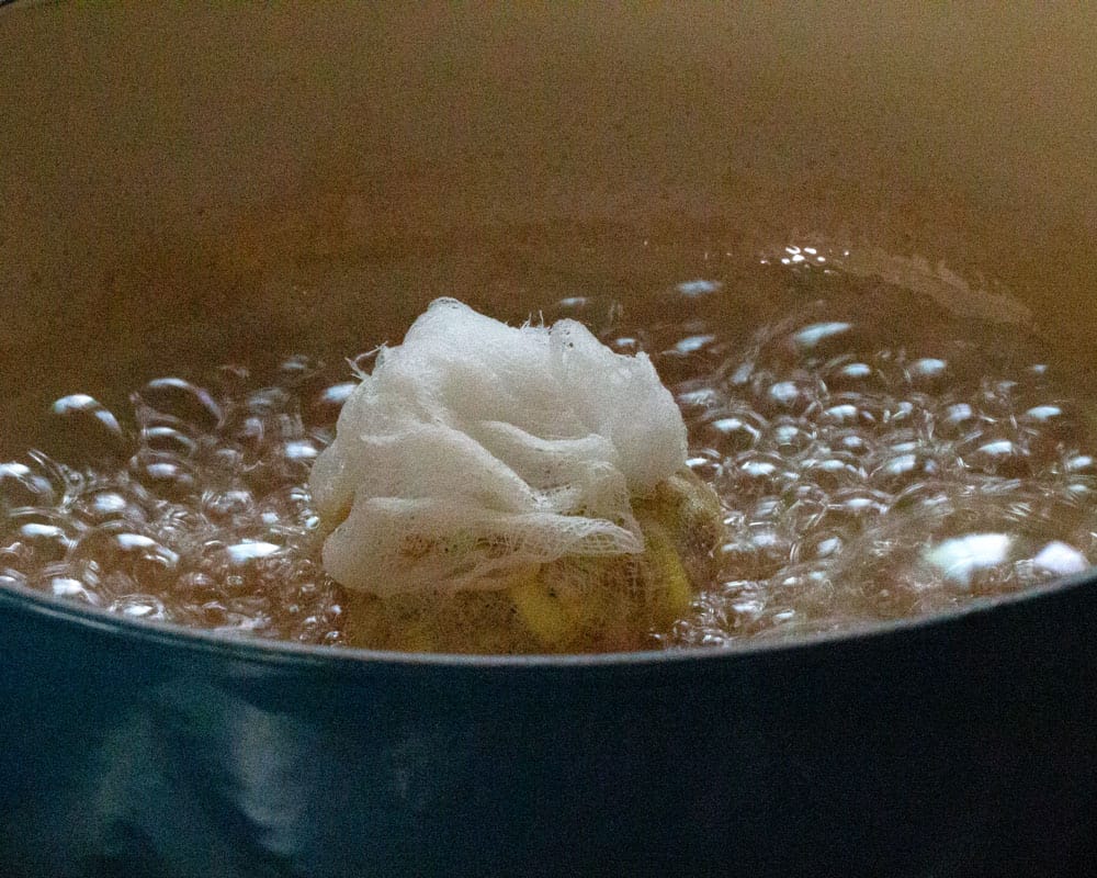 boiling "teabag" of chopped ginger in sugar syrup for making rhubarb ginger jam