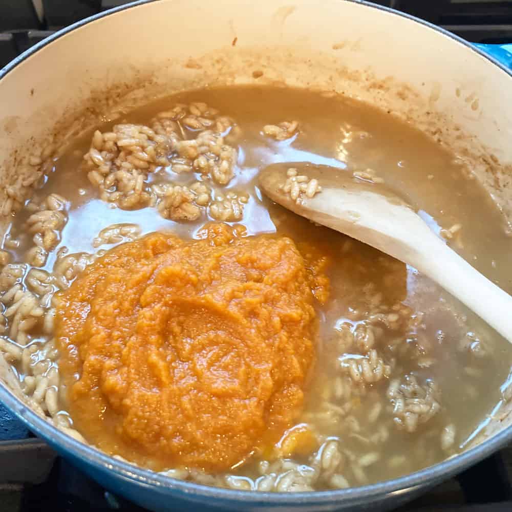 adding pumpkin and last ladle of liquid to pumpkin risotto