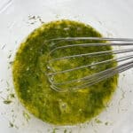 whisking eggs and herbs for matzo balls