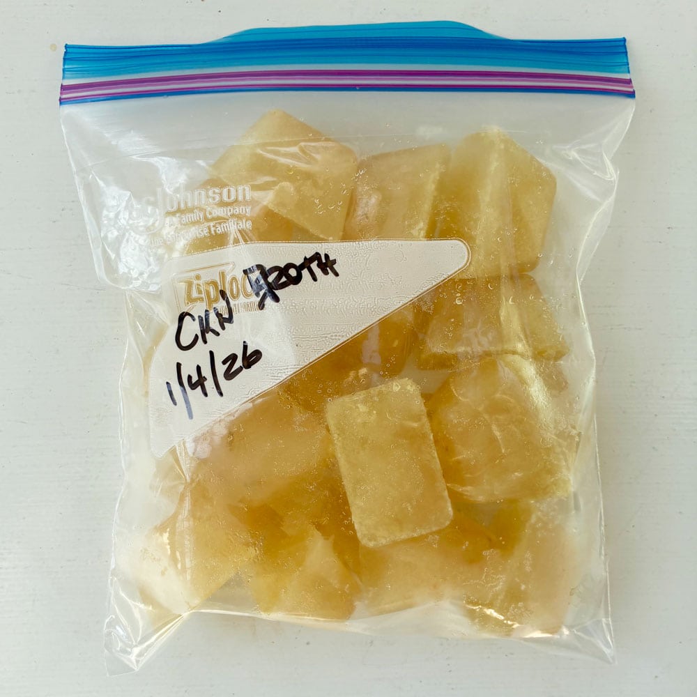 Bag of chicken broth cubes, labelled and dated for freezing.